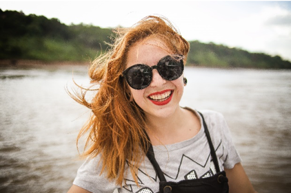 Woman near a lake smiling