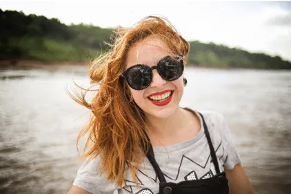 Woman near a lake smiling