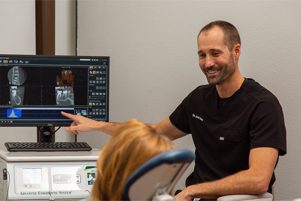 Dr. Todd showing a patient their teeth